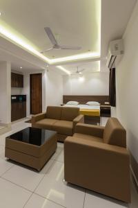 a living room with a couch and a coffee table at Hotel Karuna Residency in Mangalore