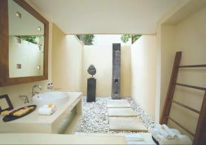 a bathroom with a sink and a mirror at Qunci Villas Resort in Senggigi