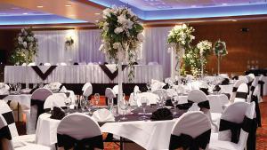 a banquet hall with white tables and chairs and flowers at Best Western Plus Boomtown Casino Hotel in Reno +37 photos