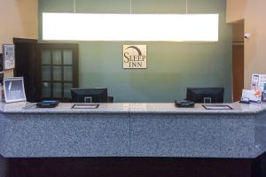 a lobby with a reception desk with a counter top at Sleep Inn Chattanooga Hamilton Place in Chattanooga