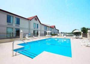 une piscine en face d'un bâtiment dans l'établissement Econo Lodge Burlington I-40, à Burlington