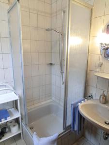 a bathroom with a shower and a tub and a sink at Weingut Hirschen Enkircherweg in Burg an der Mosel