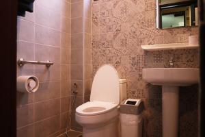 a bathroom with a toilet and a sink at Mountain View GuesthouseChiangmai in Chiang Mai