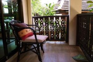 a chair with a pillow sitting on a balcony at Mountain View GuesthouseChiangmai in Chiang Mai