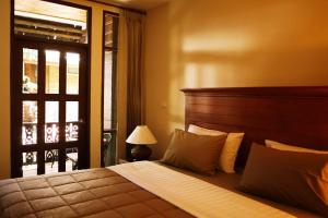 a bedroom with a large bed and a window at Mountain View GuesthouseChiangmai in Chiang Mai