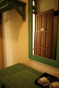 a bathroom with a green table and a mirror at Mountain View GuesthouseChiangmai in Chiang Mai