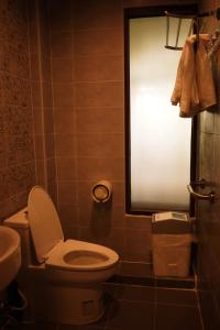 a small bathroom with a toilet and a sink at Mountain View GuesthouseChiangmai in Chiang Mai