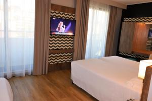 Ένα ή περισσότερα κρεβάτια σε δωμάτιο στο Hotel Domenichino