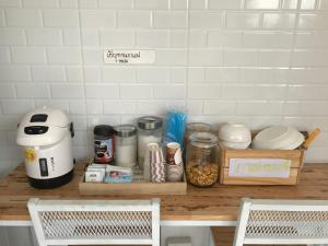 a kitchen counter with food items on a counter top at Sichon Modern House Hotel in Sichon