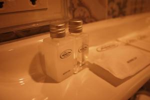 two bottles of soap sitting on top of a sink at Mountain View GuesthouseChiangmai in Chiang Mai