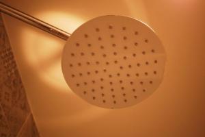 a light on a wall with a circle on it at Mountain View GuesthouseChiangmai in Chiang Mai