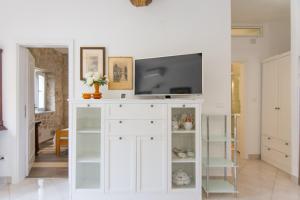 a living room with a white entertainment center with a tv at Apartment Mileta Sali in Sali