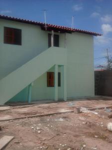 a white house with a large stairway in front of it at Costa Brasil in Coroa Vermelha