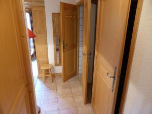 a hallway with two doors and a tile floor at Le Lièvre Blanc, appartement N°2 in Les Contamines-Montjoie