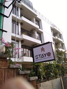 a sign for a hotel in front of a building at Stay@ in Bangalore