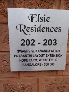 a sign on the side of a brick wall at Stay@ in Bangalore