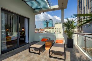 a balcony with a table and chairs on a building at Little Saigon Boutique Hotel in Ho Chi Minh City