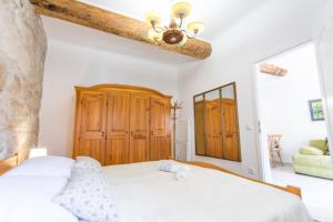 a bedroom with a white bed and a wooden cabinet at Apartment Mileta Sali in Sali