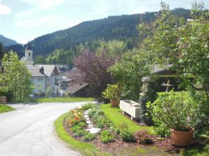 a street in a small town with flowers and trees at Haus Schönleiten in Wagrain