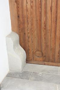 a wooden door with a stone stair case in a room at Casa Rural "ca Tona" in Chulilla