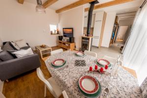 a living room with a table and a couch at Chata Tatry Resort in Veľká Lomnica