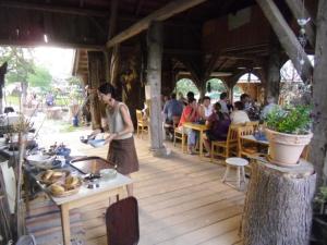 a man standing on a wooden deck in a restaurant at Reiterhof Mühlbauer in Grattersdorf