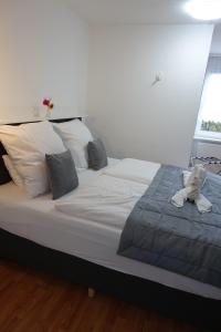 a bedroom with a white bedspread and white pillows at Stern Hotel in Leipzig