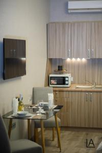 a small kitchen with a table and a microwave at Apart hotel Lake Apartments in Kyiv