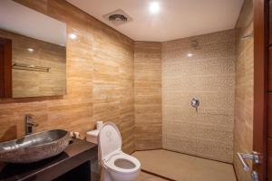 a bathroom with a toilet and a sink at Bakung Ubud Resort and Villa in Ubud