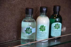 three bottles of liquid detergent sitting on a shelf at Tukonnee Villas Koh Yao Noi in Ko Yao Noi