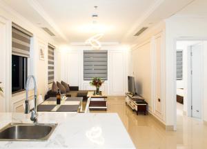 a kitchen and living room with a couch and a television at Canh Hung Palace in Hai Phong