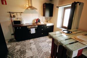 a kitchen with a sink and a counter top at Loboratorio Rural, La Casa de al Lado in Casas del Abad