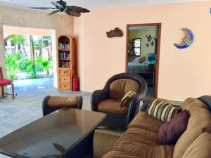 a living room with two couches and a table at Nah Uxibal Villa and Casitas in Tulum