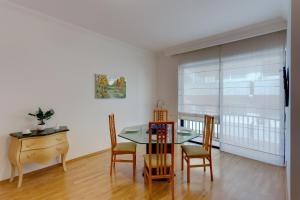 a dining room with a table and chairs and a desk at Central Apartment in St Julian's, Perfect for Families in St. Julianʼs