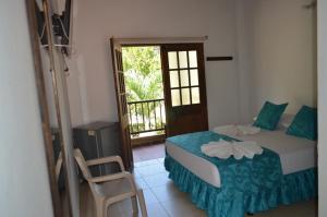 a bedroom with a bed and a door to a balcony at Hotel Campestre La Ribera del Fonce in San Gil +63 photos
