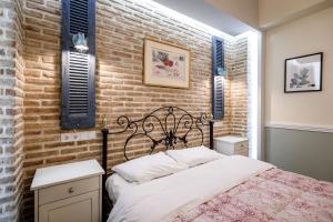 a bedroom with a bed and a brick wall at pension Acronafplia B&D in Nafplio