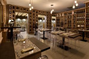 a restaurant with tables and chairs in a room at Hotel Parco Degli Aromi Resort & SPA in Valderice