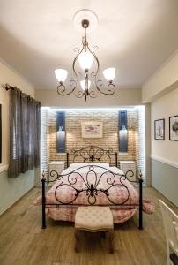 a bedroom with a bed and a chandelier at Acronafplia Pension B&D in Nafplio