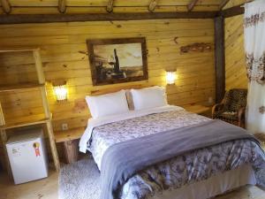 Una cama o camas en una habitación de Pousada Serra Catarinense