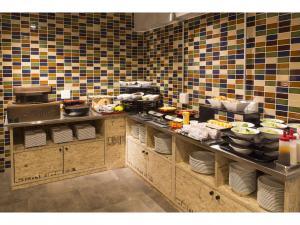 a kitchen with plates and utensils on a counter at Hotel Replace Namba Osaka in Osaka