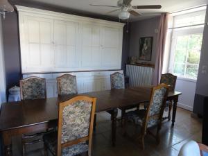 - une salle à manger avec une table et des chaises en bois dans l'établissement LA BELLE D'ANTAN, à Saint-Bonnet-en-Bresse