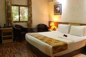 Ένα ή περισσότερα κρεβάτια σε δωμάτιο στο Palm Hotel