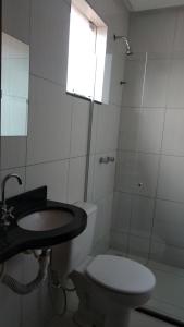 a bathroom with a toilet and a sink and a shower at Pousada Santana - Trindade Goiás in Trindade