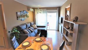 una sala de estar con una mesa y un sofá en Helena Seaview & Beach-apartment, en Montgat 50 fotos más
