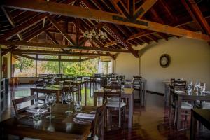a dining room with wooden tables and chairs at Ayres del Champaqui Hotel Boutique Experiencial & Spa in Villa General Belgrano