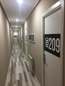 a hallway with a sign on the wall at JQC Rooms in Madrid