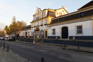 a large building on the side of a street at Oak Tree Guest House in Azeitao