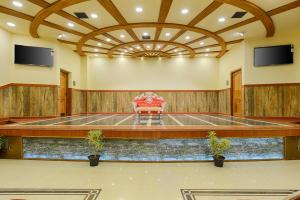 a large room with a table and a chair at Hotel Ramraj Regency in Nāgercoil