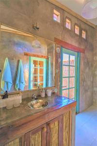 a bathroom with a sink and a mirror at Casita La Brea in San Pedro de Atacama