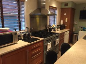 a kitchen with a stove and a counter top at The Mayfair guest house self catering in Southampton